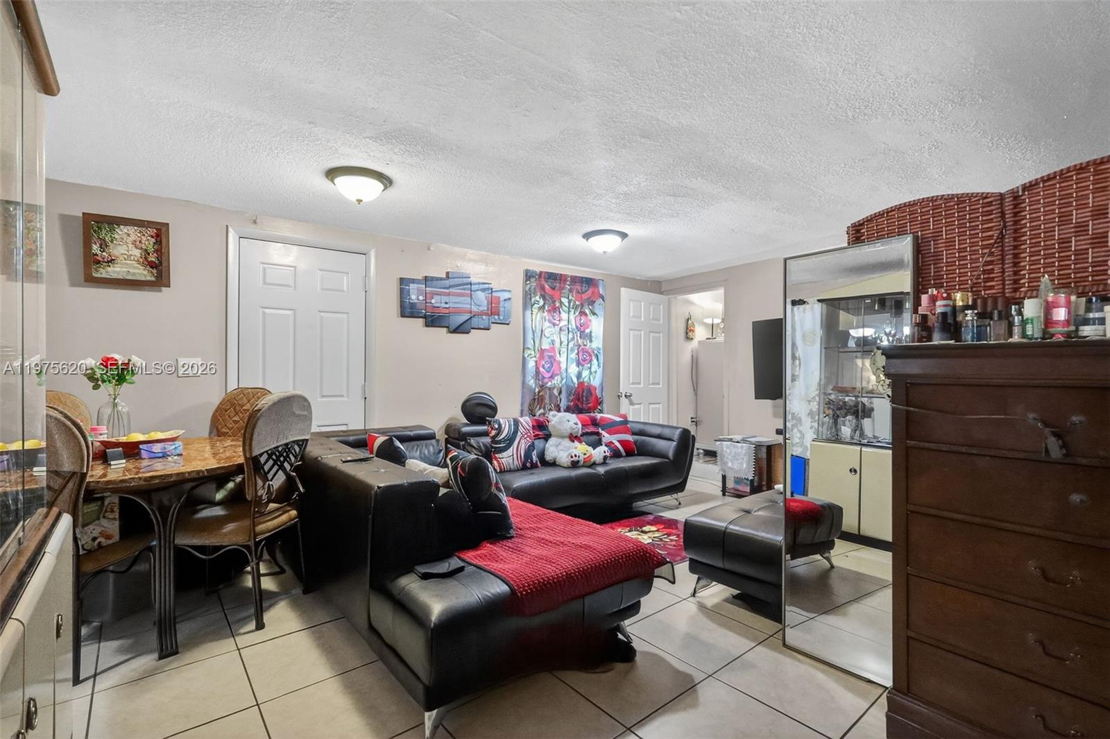 834 Northwest 115th Street Miami, FL 33168 - Photo 34 of 46 a living room with furniture a flat screen tv and a window