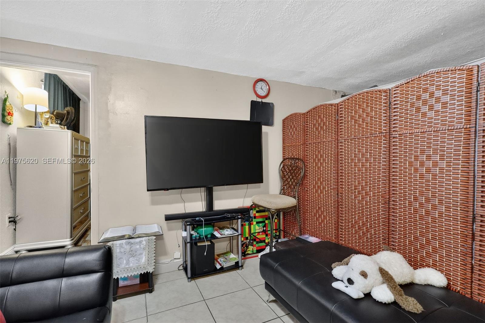834 Northwest 115th Street Miami, FL 33168 - Photo 35 of 46 a living room with furniture and a flat screen tv