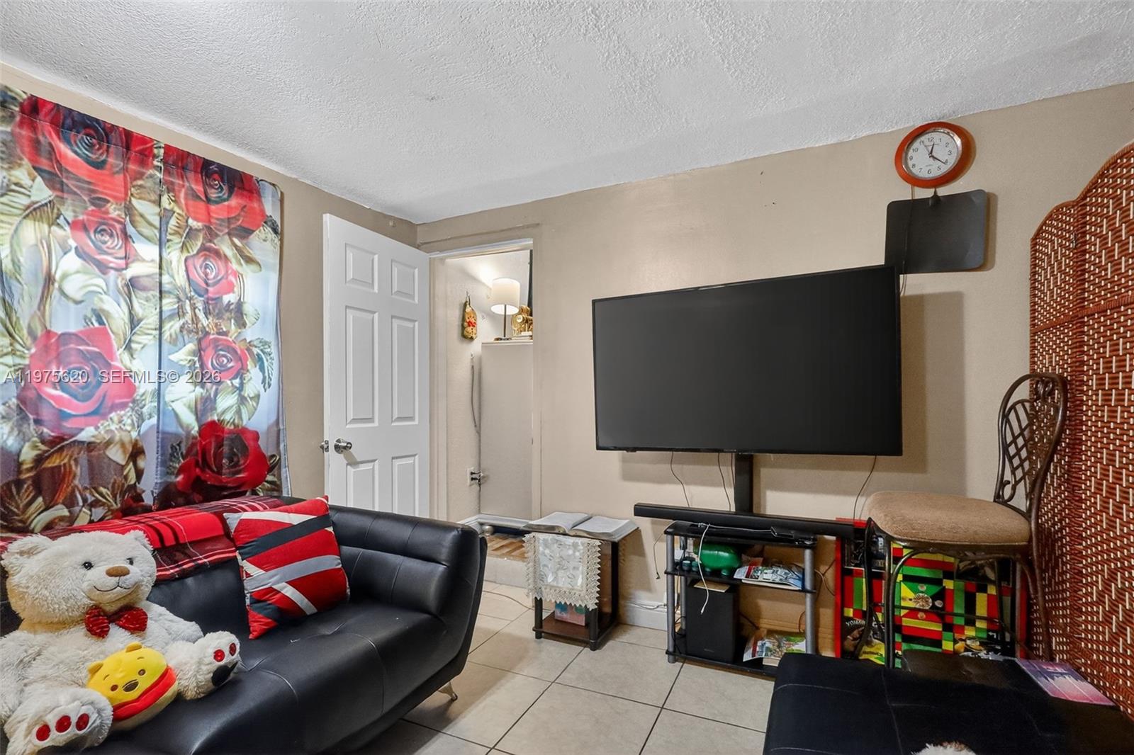 834 Northwest 115th Street Miami, FL 33168 - Photo 36 of 46 a living room with furniture and a flat screen tv