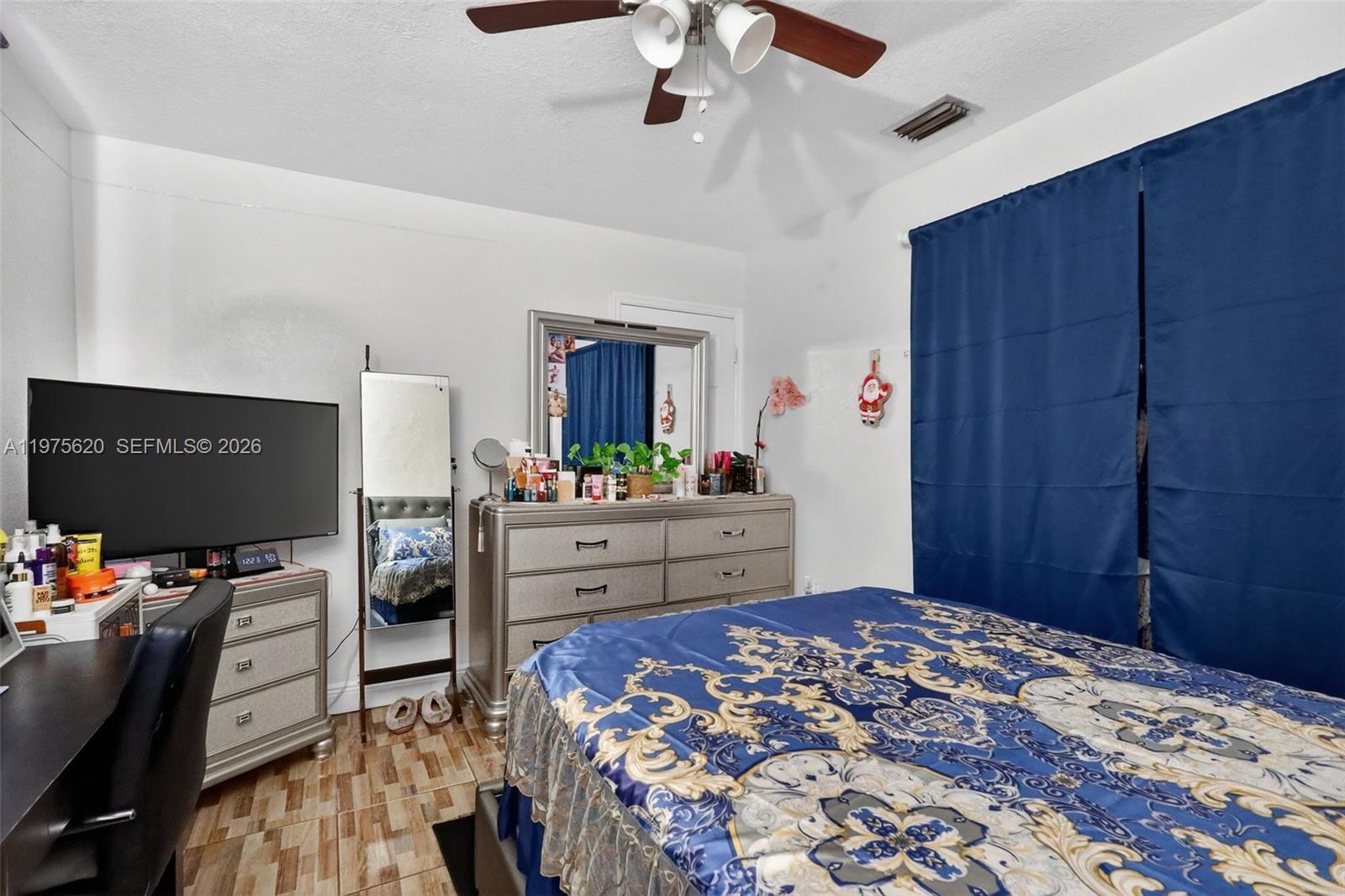 834 Northwest 115th Street Miami, FL 33168 - Photo 38 of 46 a bedroom with a bed and wooden floor