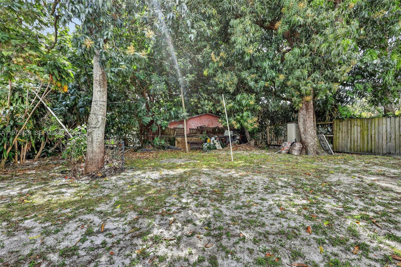 834 Northwest 115th Street Miami, FL 33168 - Photo 43 of 46 a backyard of a house with lots of green space