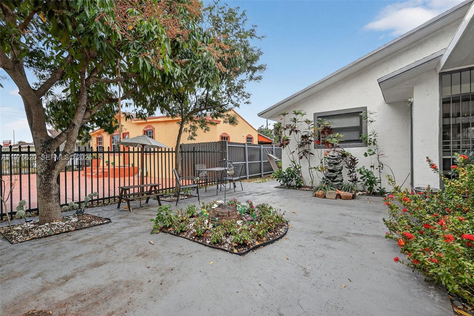 834 Northwest 115th Street Miami, FL 33168 - Photo 5 of 46 a front view of a house having garden