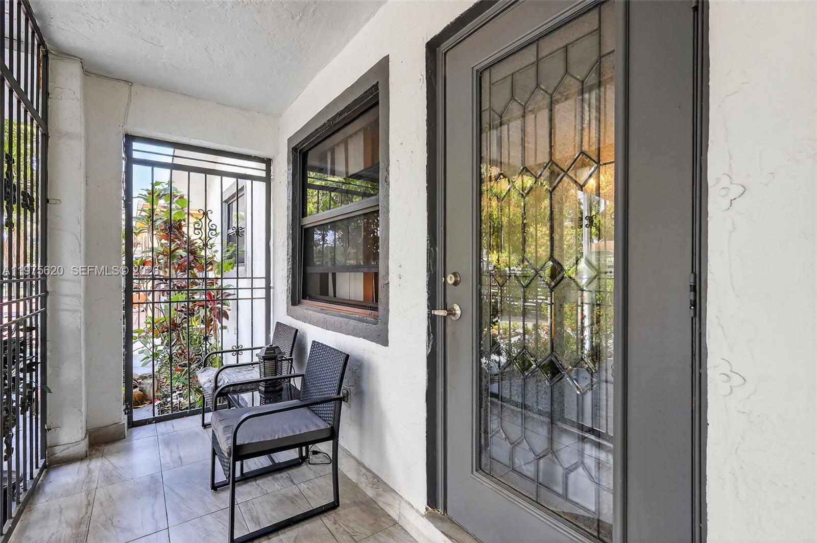 834 Northwest 115th Street Miami, FL 33168 - Photo 8 of 46 a living room with furniture and a floor to ceiling window