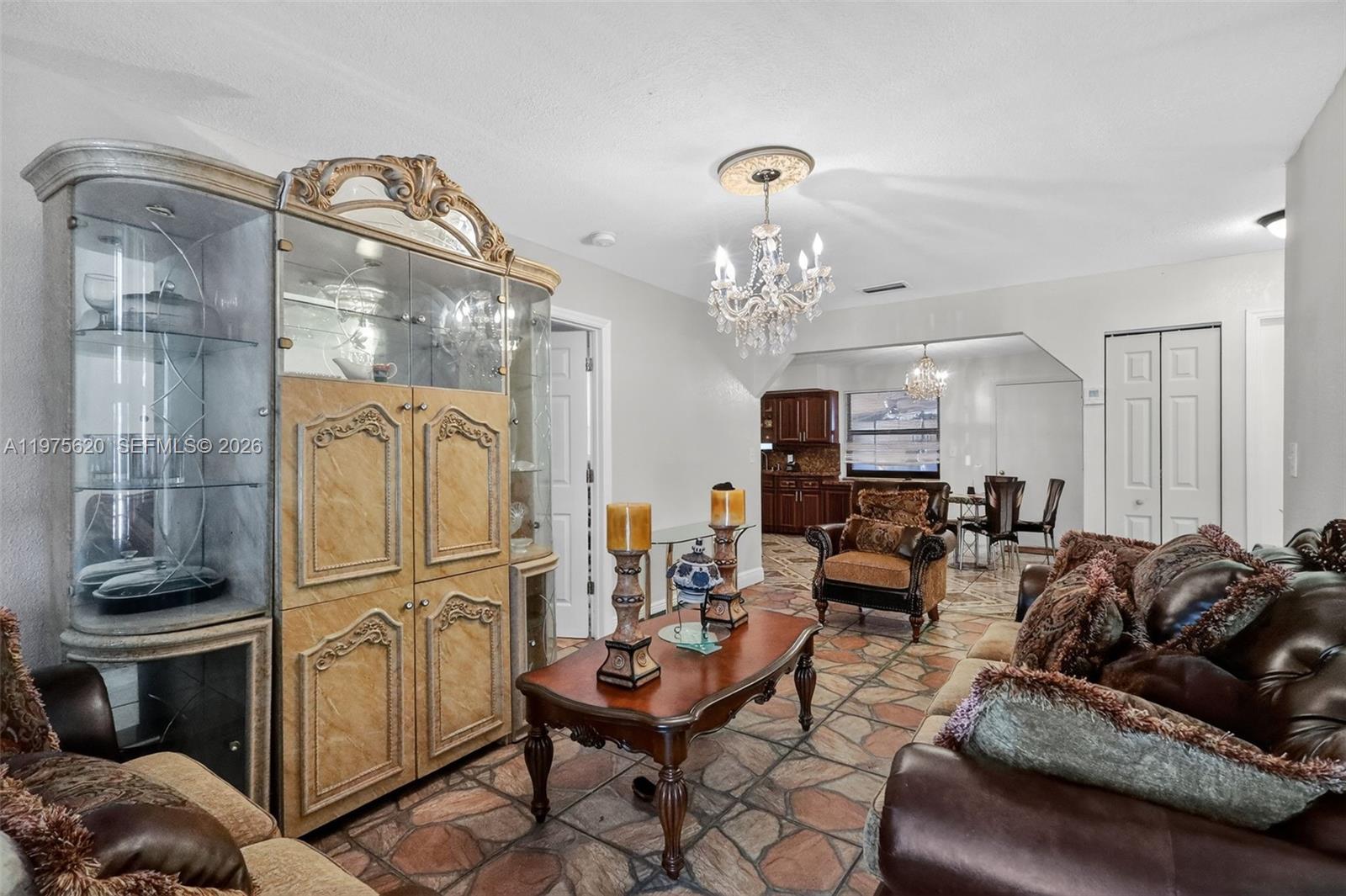 834 Northwest 115th Street Miami, FL 33168 - Photo 9 of 46 a living room with furniture and a chandelier