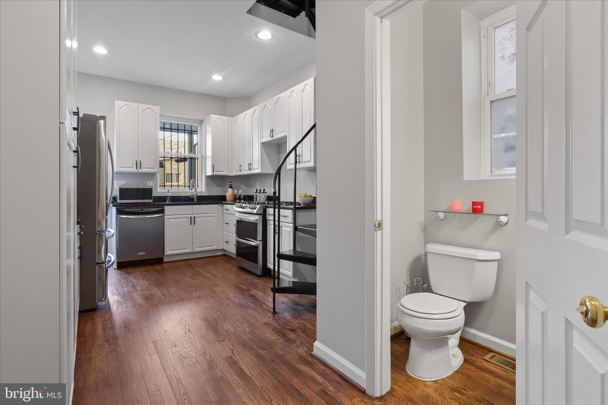 1327 Harvard Street Northwest Washington, DC 20009 - Photo 13 of 61 a bathroom with a toilet sink and refrigerator