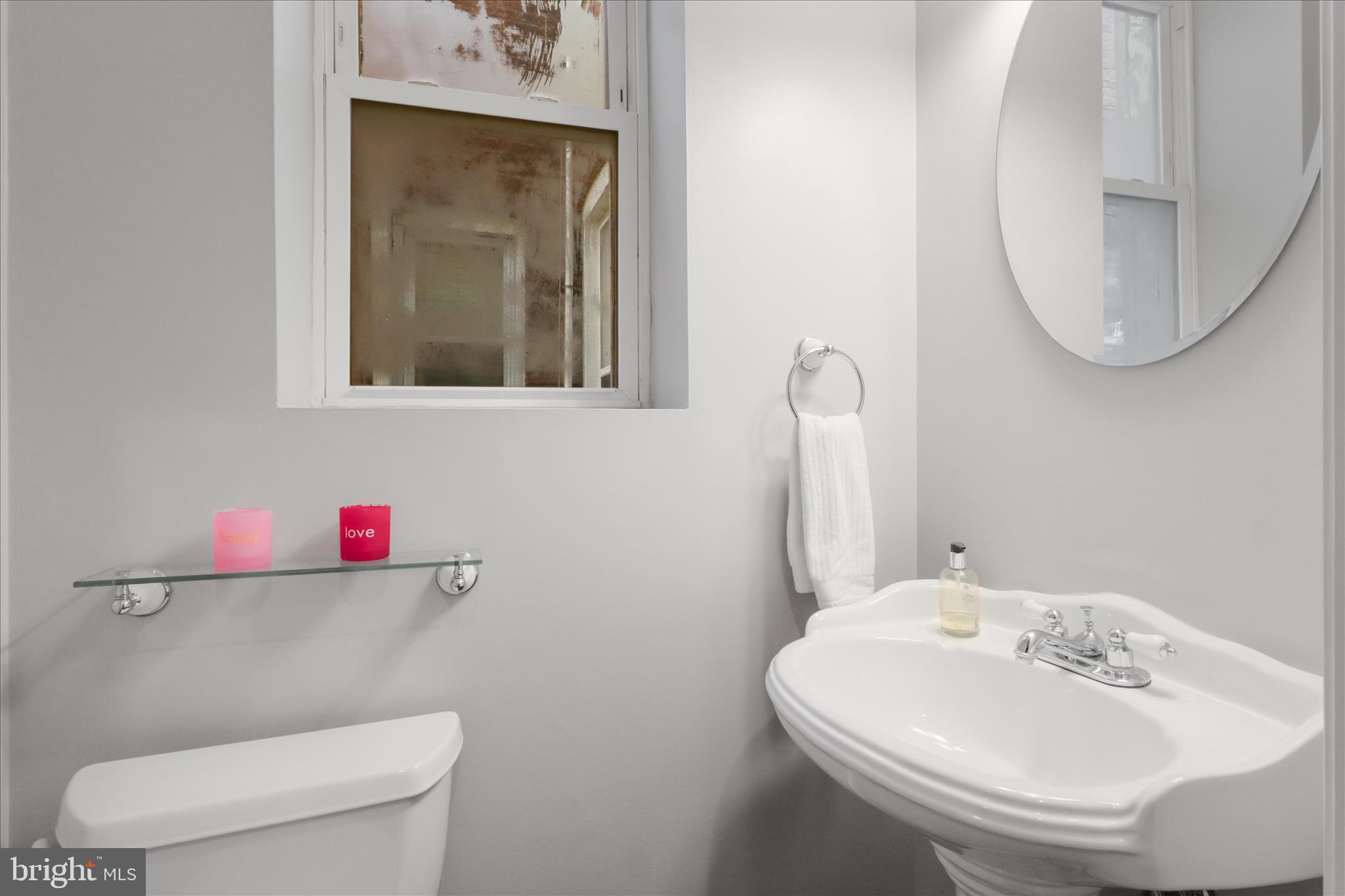 1327 Harvard Street Northwest Washington, DC 20009 - Photo 18 of 61 a bathroom with a toilet sink and mirror