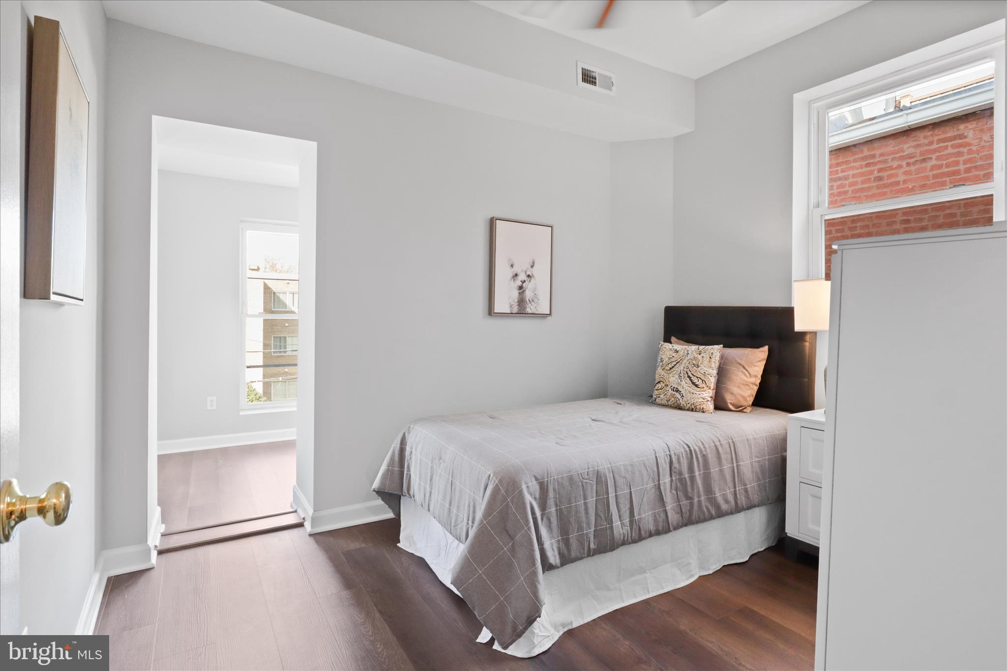 1327 Harvard Street Northwest Washington, DC 20009 - Photo 25 of 61 a bedroom with a bed and a window