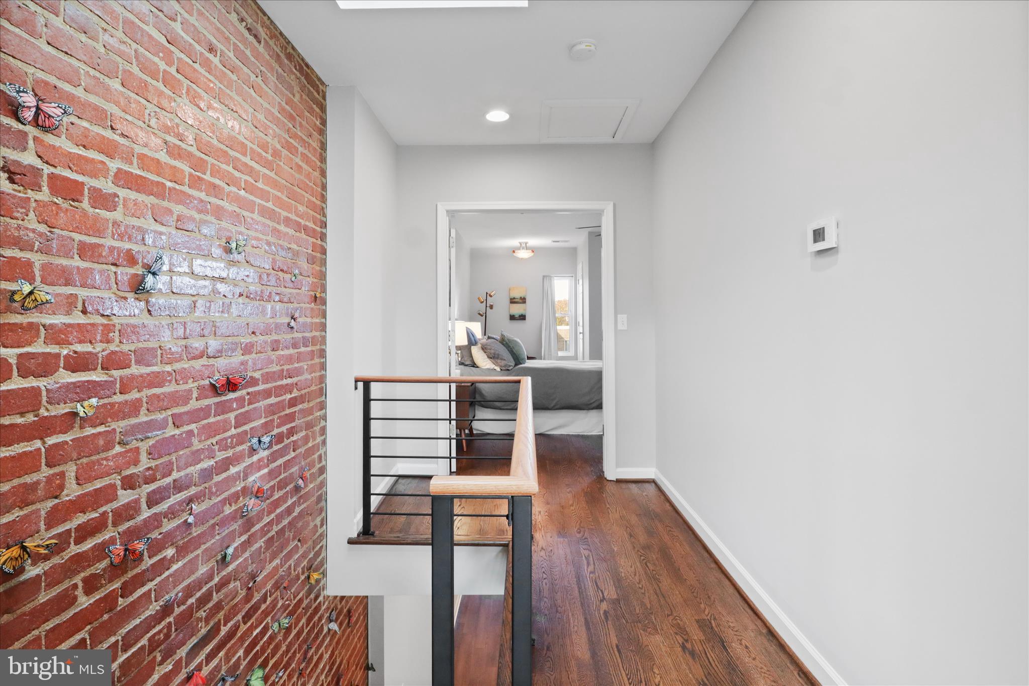 1327 Harvard Street Northwest Washington, DC 20009 - Photo 31 of 61 a hallway with wooden floor and furniture