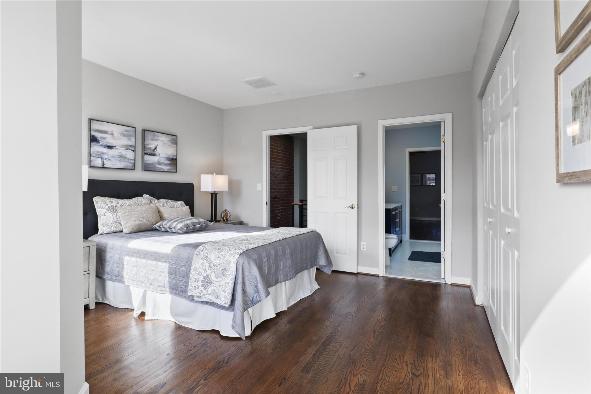 1327 Harvard Street Northwest Washington, DC 20009 - Photo 40 of 61 a spacious bedroom with a bed and wooden floor