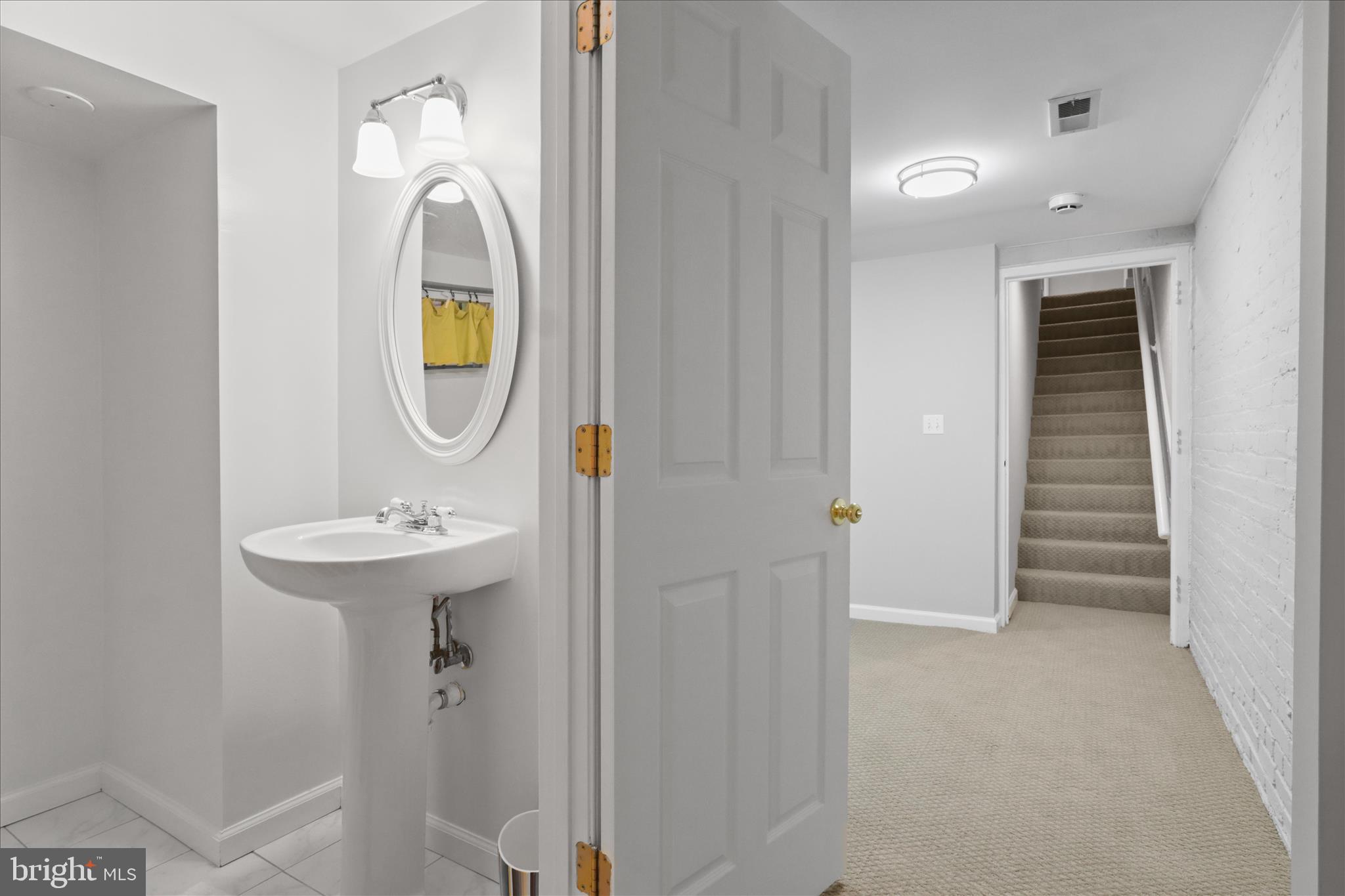 1327 Harvard Street Northwest Washington, DC 20009 - Photo 47 of 61 a bathroom with a sink and a mirror