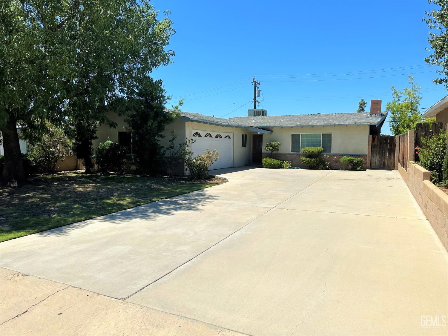 Undisclosed Address Bakersfield, CA 93306 - Photo 2 of 24 a front view of a house with a yard