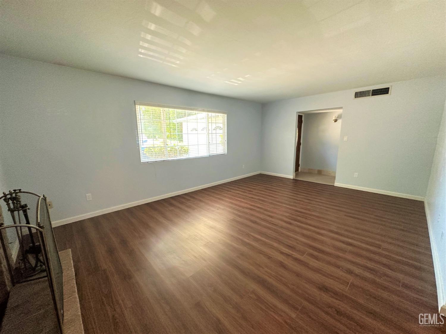 Undisclosed Address Bakersfield, CA 93306 - Photo 24 of 24 an empty room with wooden floor and windows