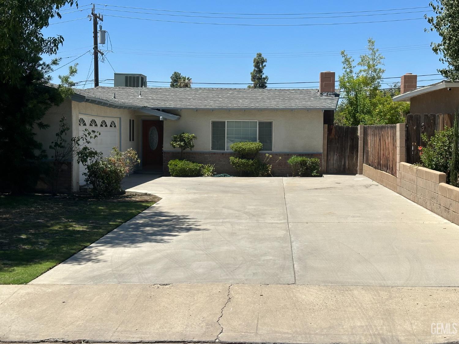 Undisclosed Address Bakersfield, CA 93306 - Photo 3 of 24 a front view of a house with a yard