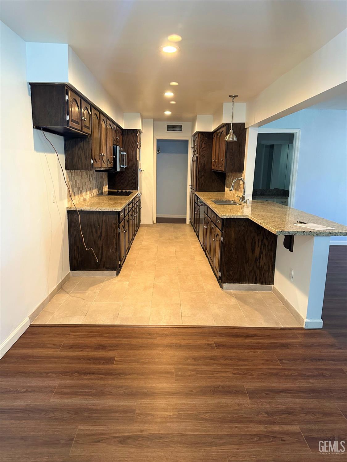 Undisclosed Address Bakersfield, CA 93306 - Photo 7 of 24 a large kitchen with stainless steel appliances a large counter top a stove and a refrigerator