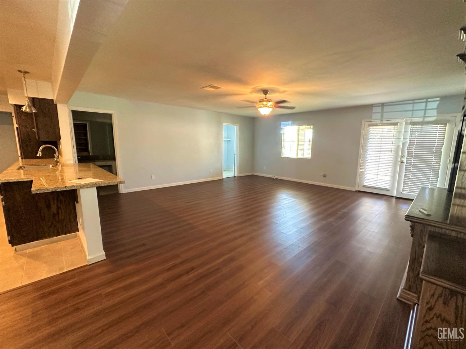 Undisclosed Address Bakersfield, CA 93306 - Photo 8 of 24 a view of a room with wooden floor and a window