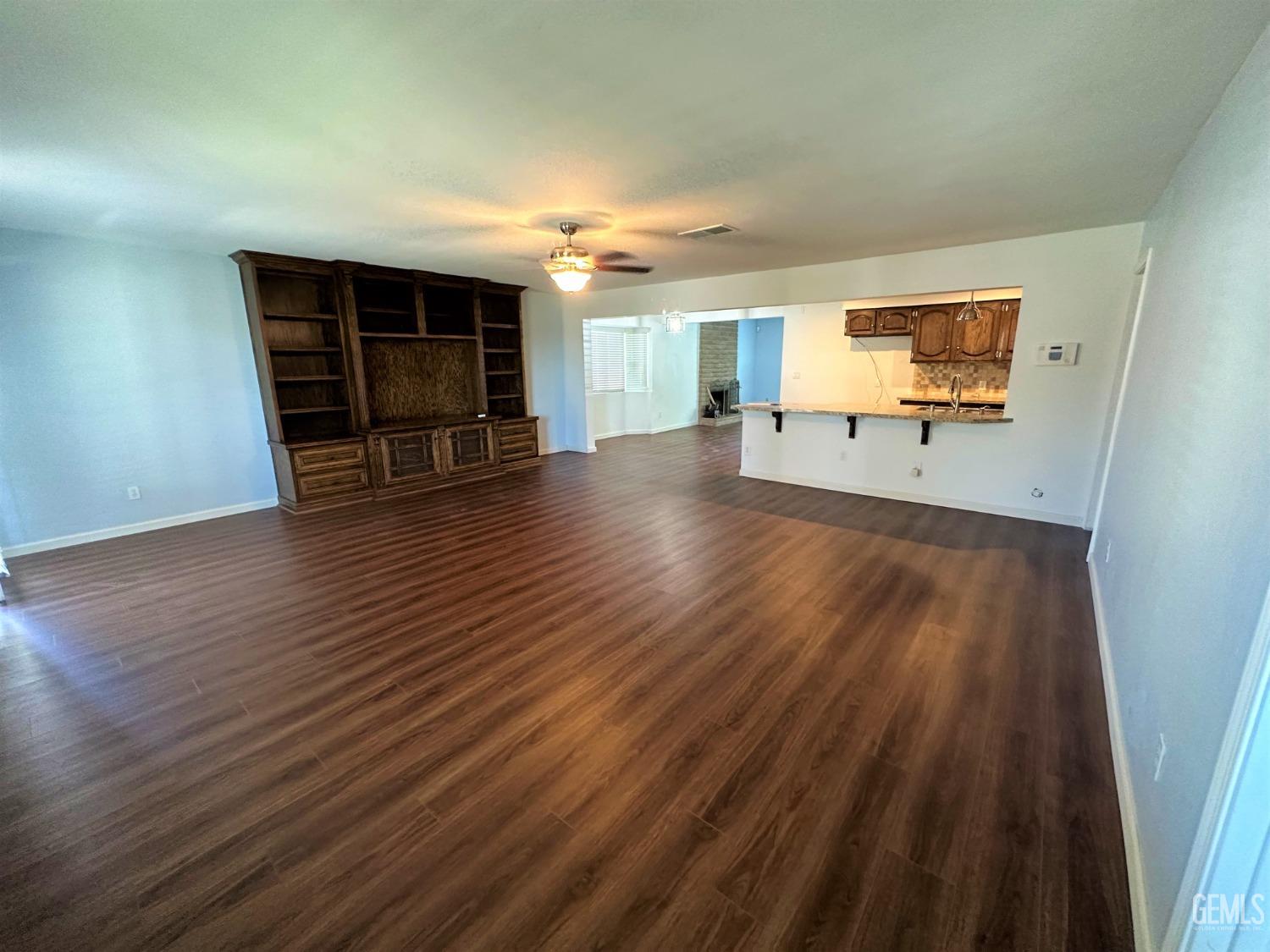 Undisclosed Address Bakersfield, CA 93306 - Photo 9 of 24 a view of empty room with wooden floor and windows