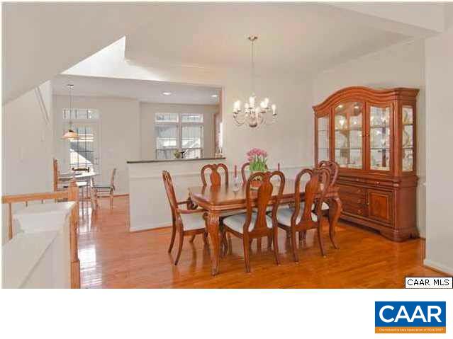 337 Rolkin Road Charlottesville, VA 22911 - Photo 5 of 18 a view of dining room and livingroom with furniture wooden floor a rug a potted plant and a chandelier