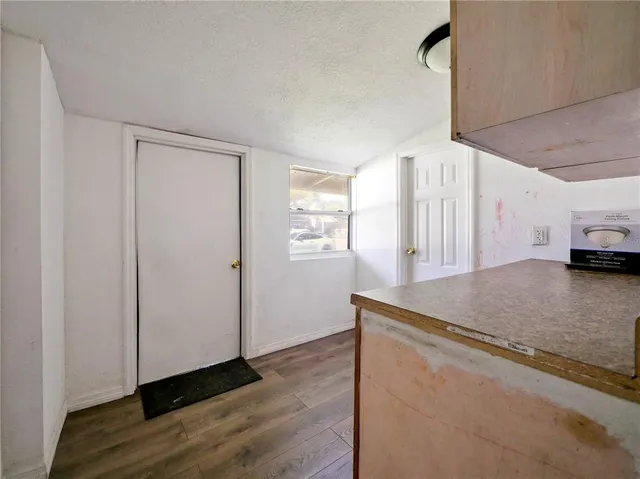 a view of a kitchen with wooden floor
