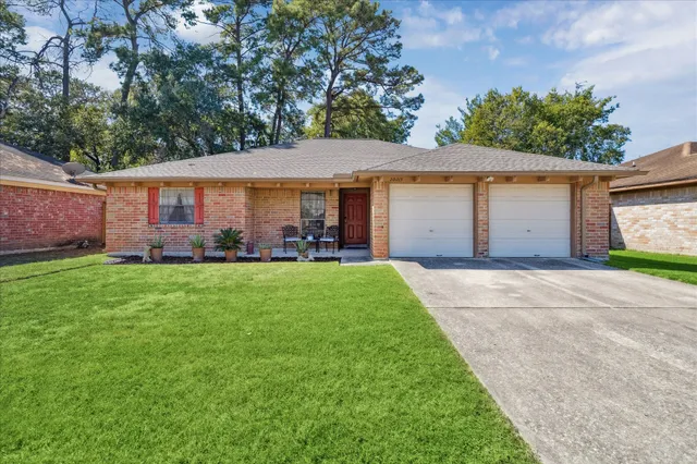 a front view of a house with a garden and plants