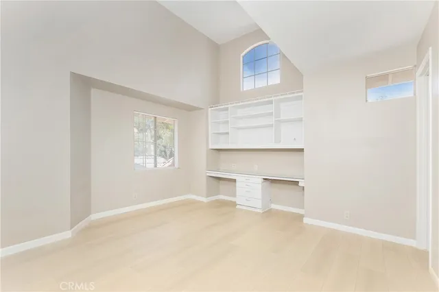 a view of a room that has a bed and window