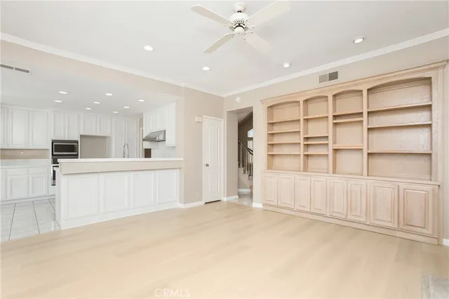a view of an empty room with a cabinet and mirrors