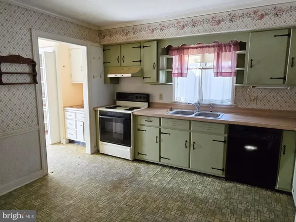 a kitchen with a stove sink and cabinets