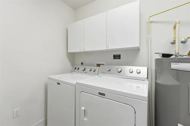 a kitchen with granite countertop kitchen island stainless steel appliances a sink stove and refrigerator