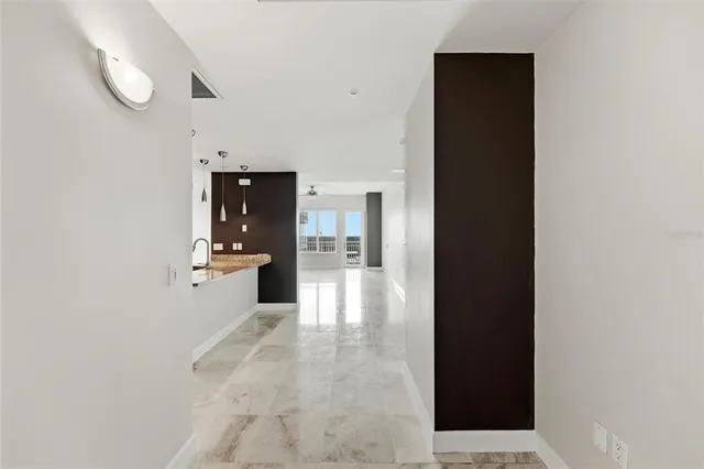 a kitchen with stainless steel appliances granite countertop a sink refrigerator and cabinets