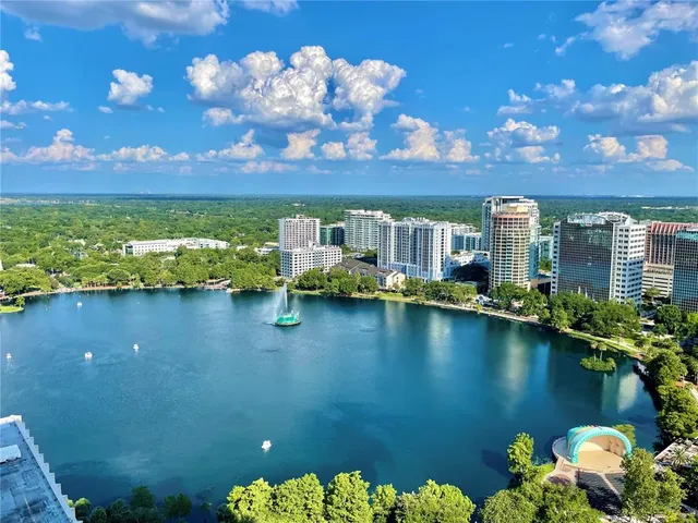 a view of an chairs and table in a big yard