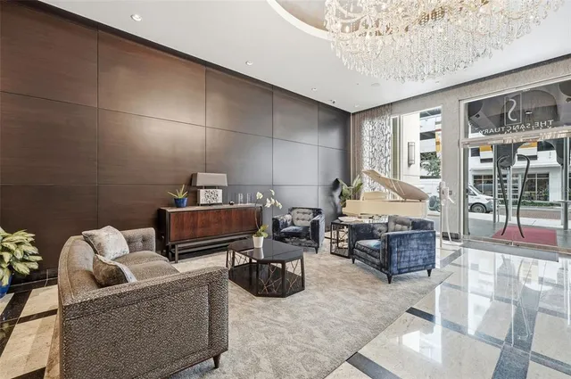 a living room with furniture and a chandelier