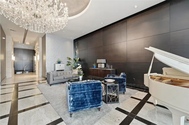 a living room with furniture and a chandelier