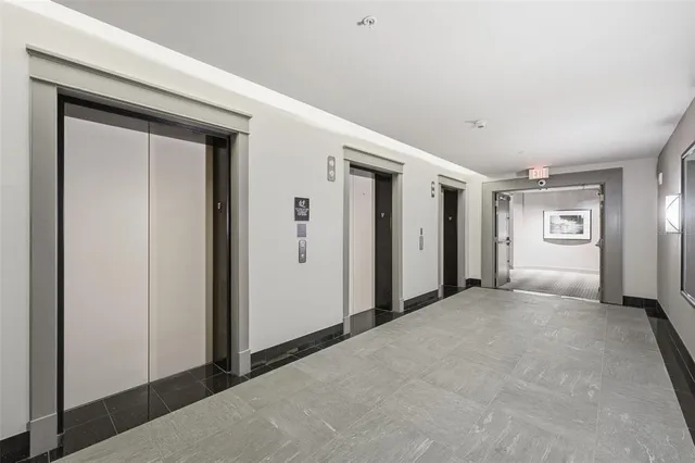 a view of a hallway with wooden floor and closet