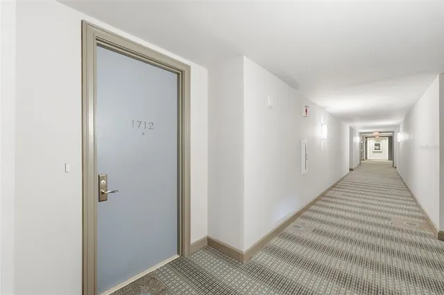 a large kitchen with kitchen island a large counter top stainless steel appliances and cabinets