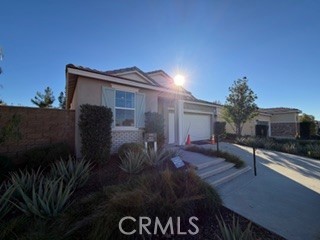 a backyard of a house with table and chairs with wooden fence