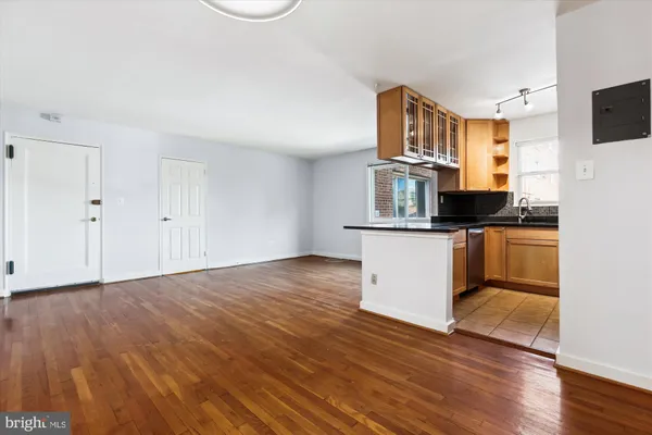 a view of a kitchen with wooden floor electronic appliances and window
