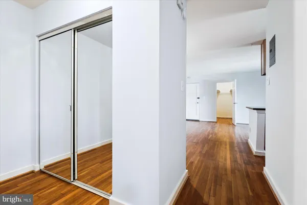 a view of a hallway with wooden floor