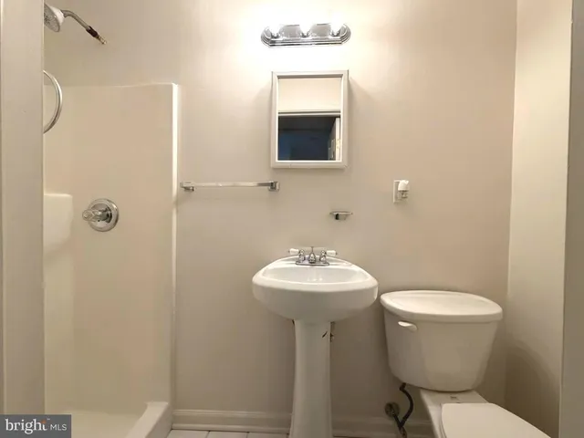 a bathroom with a sink toilet and mirror