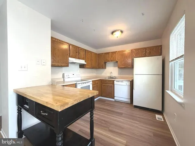 a kitchen with a sink a refrigerator and a stove