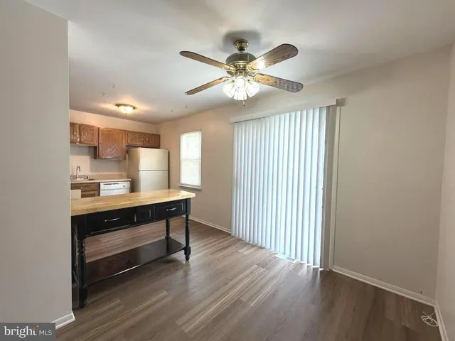 a view of room with wooden floor and window
