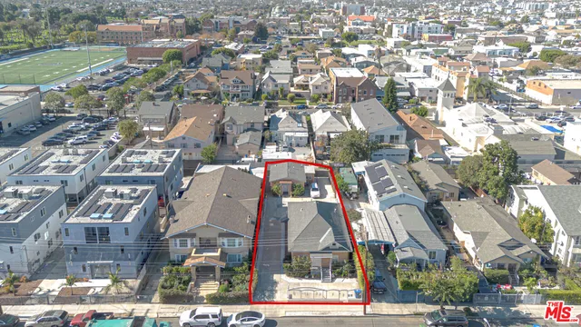 an aerial view of residential houses with outdoor space