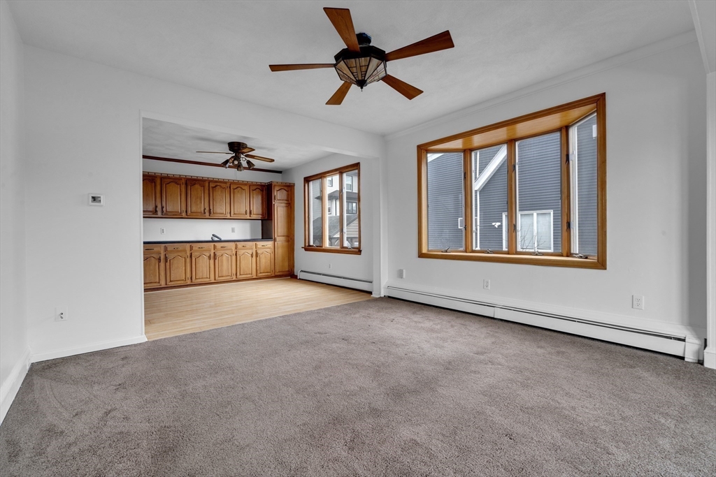 18 Butler Street Revere, MA 02151 - Photo 14 of 33 a view of an empty room with a window and kitchen view