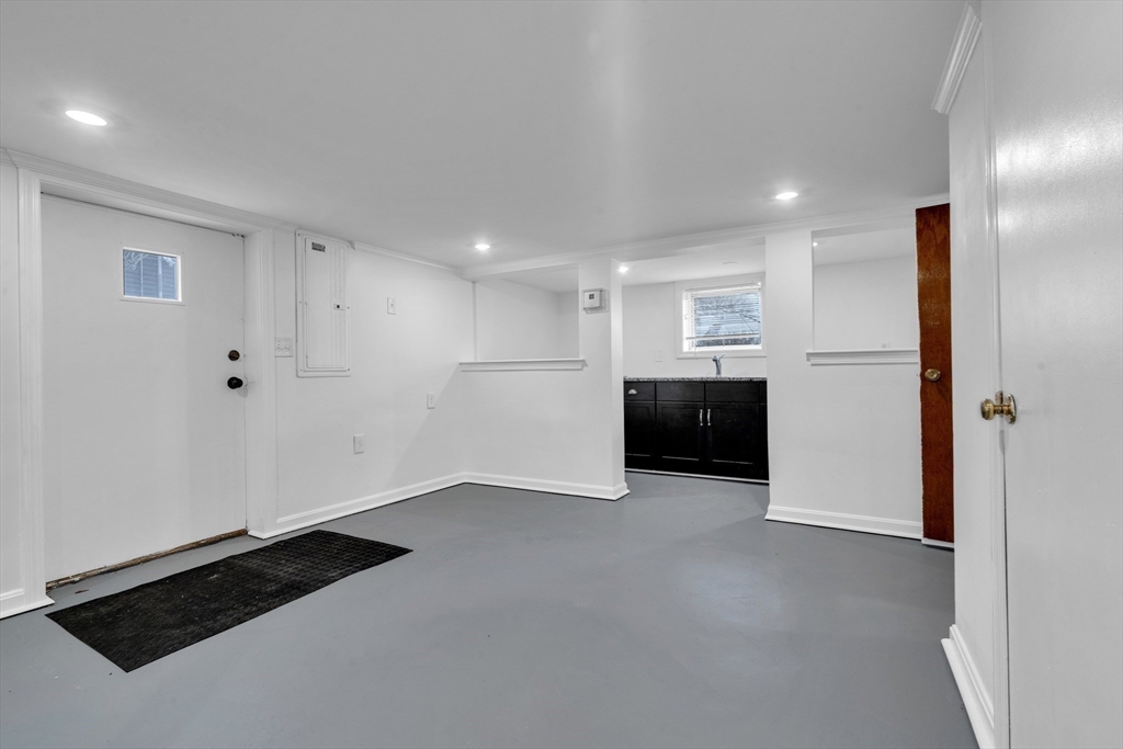 18 Butler Street Revere, MA 02151 - Photo 18 of 33 a view of kitchen with refrigerator and white cabinets