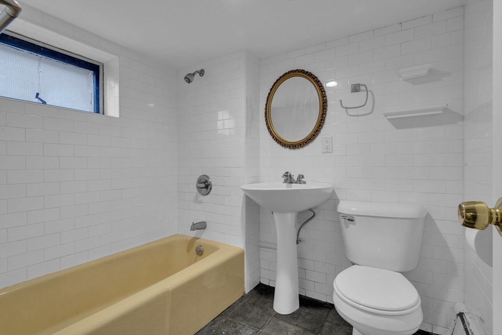 18 Butler Street Revere, MA 02151 - Photo 19 of 33 a bathroom with a sink a toilet and a bathtub