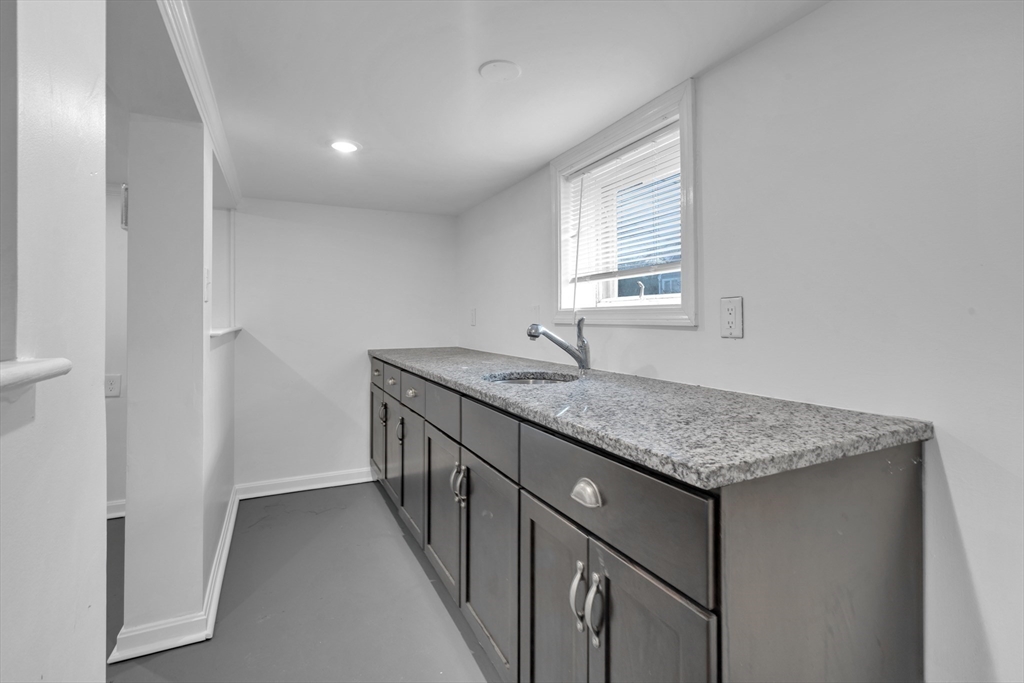 18 Butler Street Revere, MA 02151 - Photo 20 of 33 a bathroom with a granite countertop sink and a window