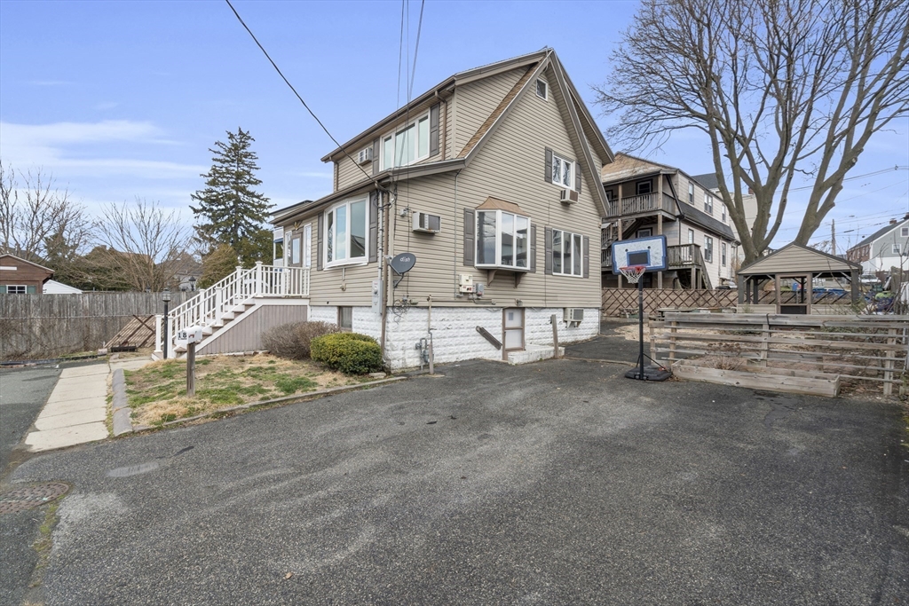 18 Butler Street Revere, MA 02151 - Photo 27 of 33 a view of a white house with a yard and road