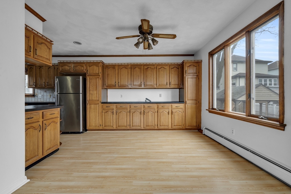 18 Butler Street Revere, MA 02151 - Photo 5 of 33 a kitchen with stainless steel appliances kitchen island granite countertop a refrigerator oven a sink and dishwasher with wooden floor