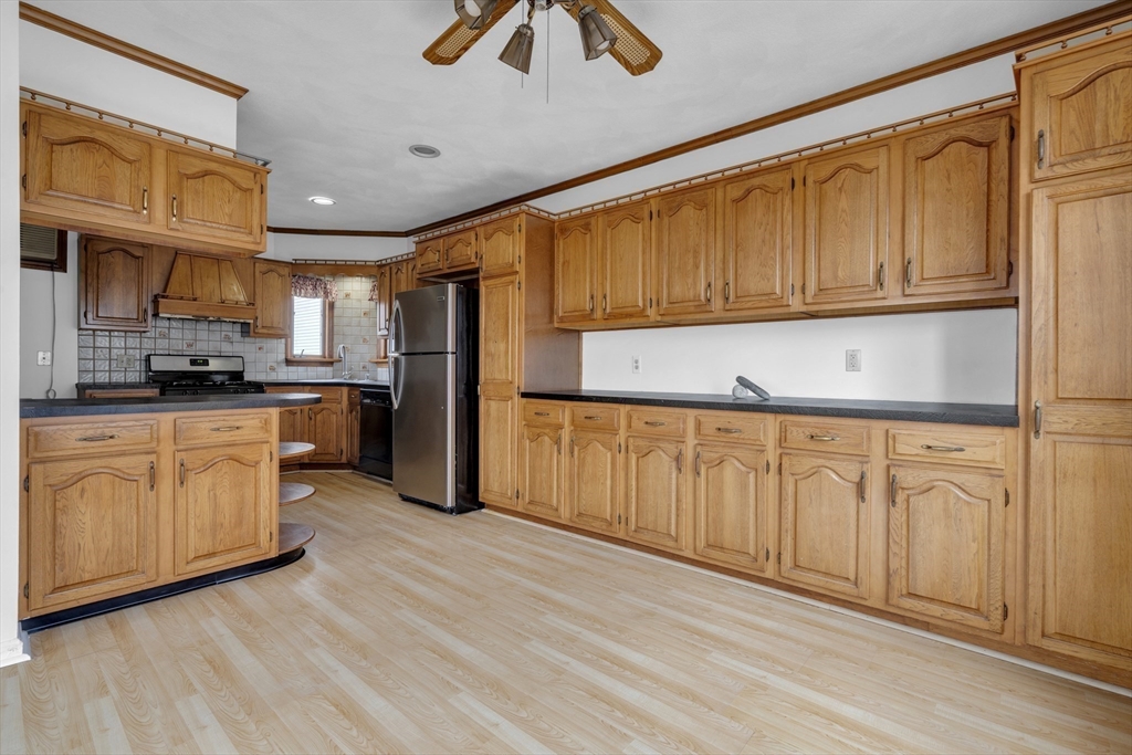 18 Butler Street Revere, MA 02151 - Photo 6 of 33 a kitchen with cabinets a sink and appliances