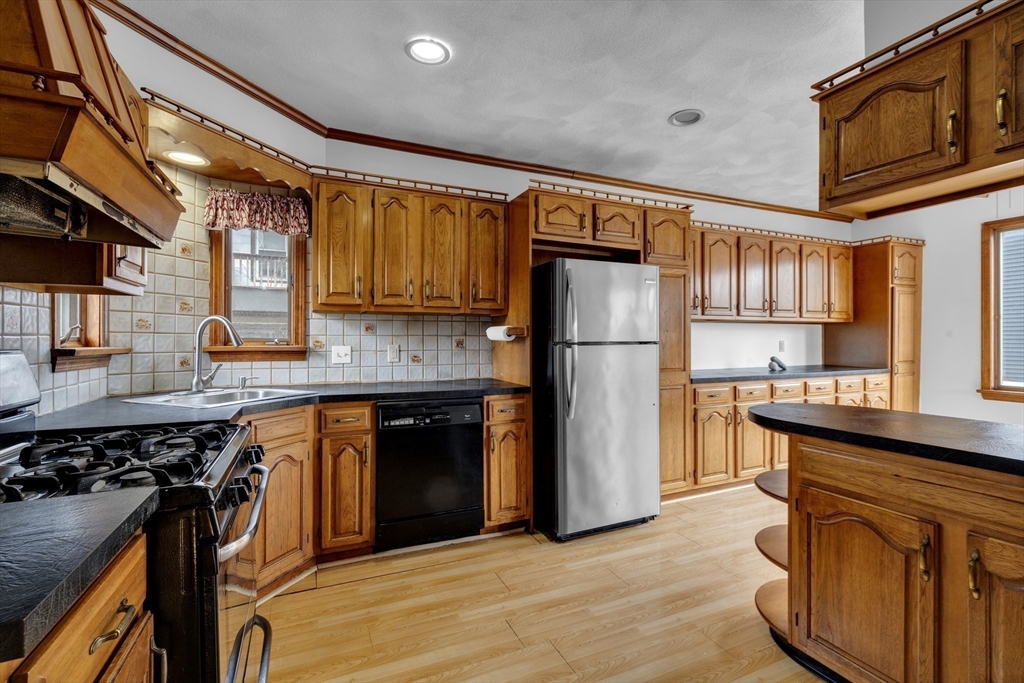 18 Butler Street Revere, MA 02151 - Photo 8 of 33 a kitchen with a refrigerator and a sink