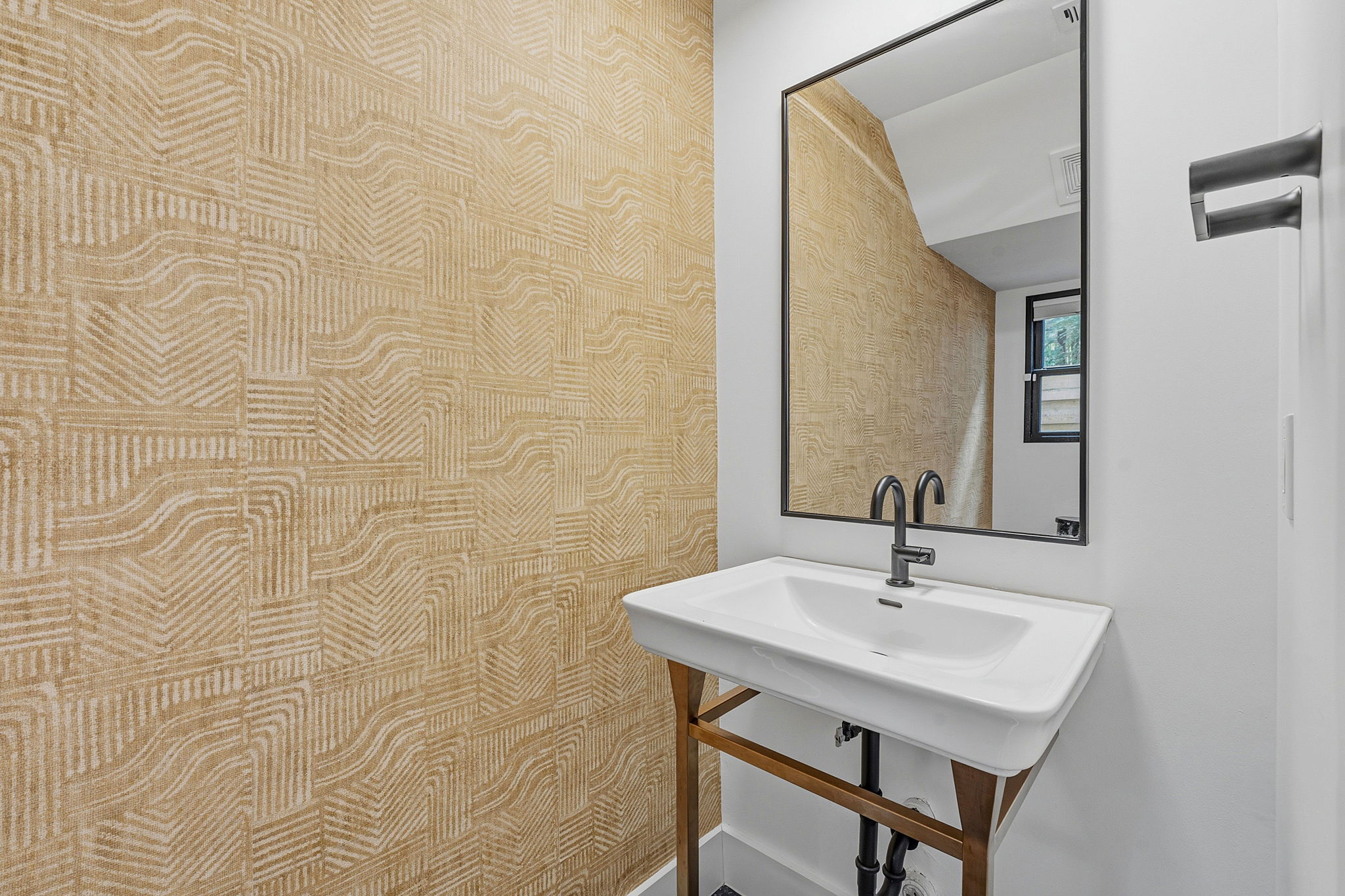 2004 Riverview Street Austin, TX 78702 - Photo 12 of 36 Textured wall covering with a geometric pattern, featuring a rectangular vanity mirror with a black frame