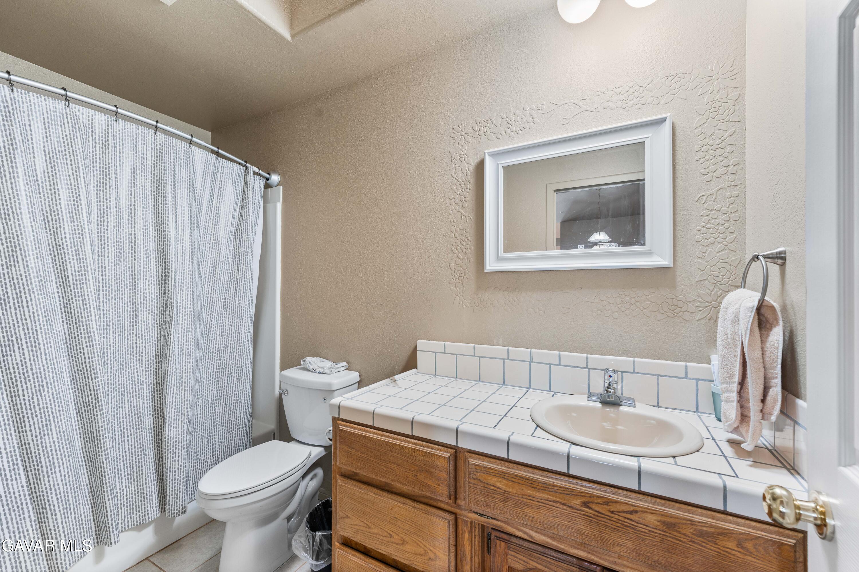 13275 Boy Scout Camp Road Frazier Park, CA 93225 - Photo 39 of 90 a bathroom with a granite countertop sink and a toilet